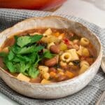 A bowl of plant-based minestrone ready to eat.
