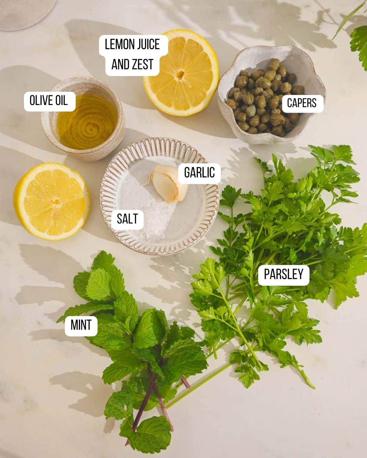 Ingredients for the lemon, parsley and caper salsa verde laid out ready to use.