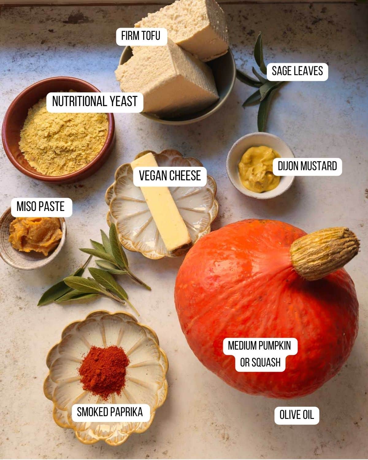 Ingredients for the hot cheese dip in a pumpkin laid out.