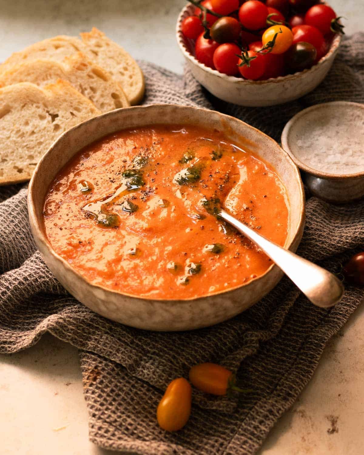 The roasted red pepper and tomato soup ready to eat in a bowl.