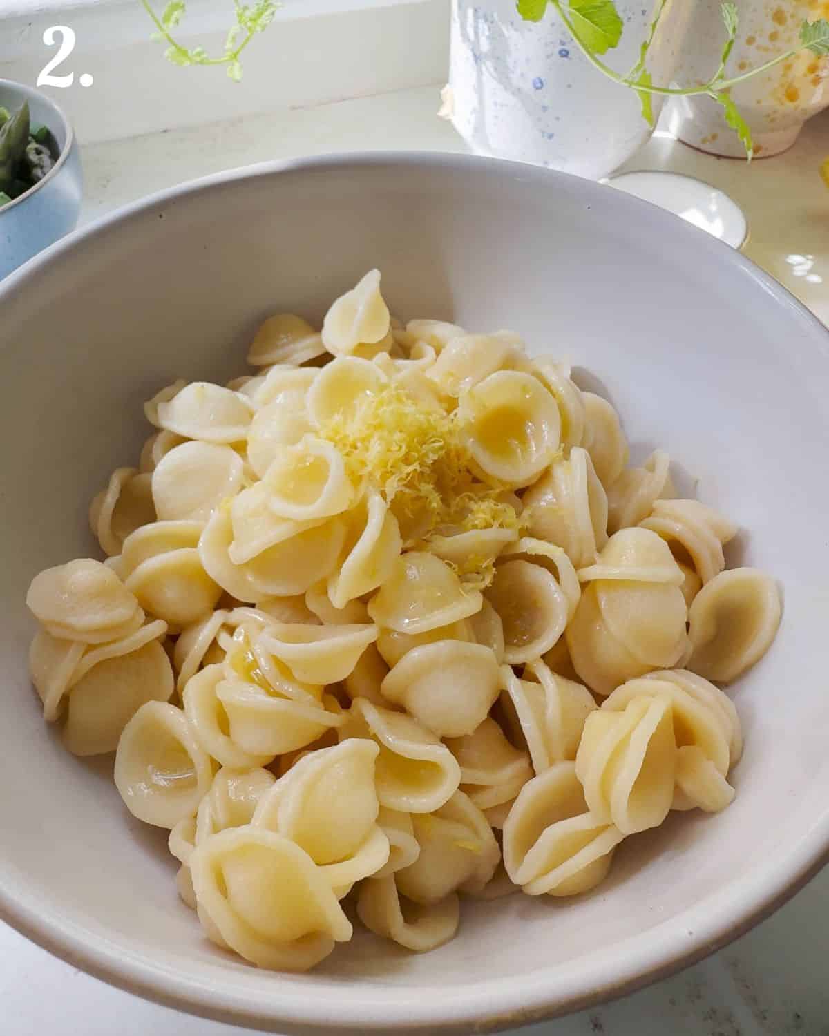 Dress the pasta while still slightly warm with lemon dressing.