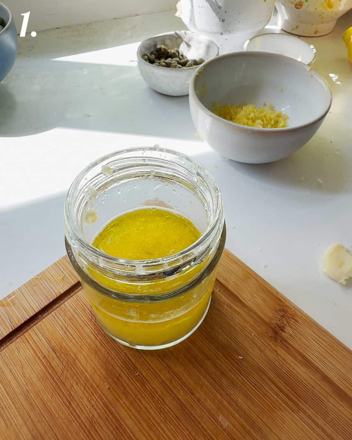 The lemon dressing being made in a jar.