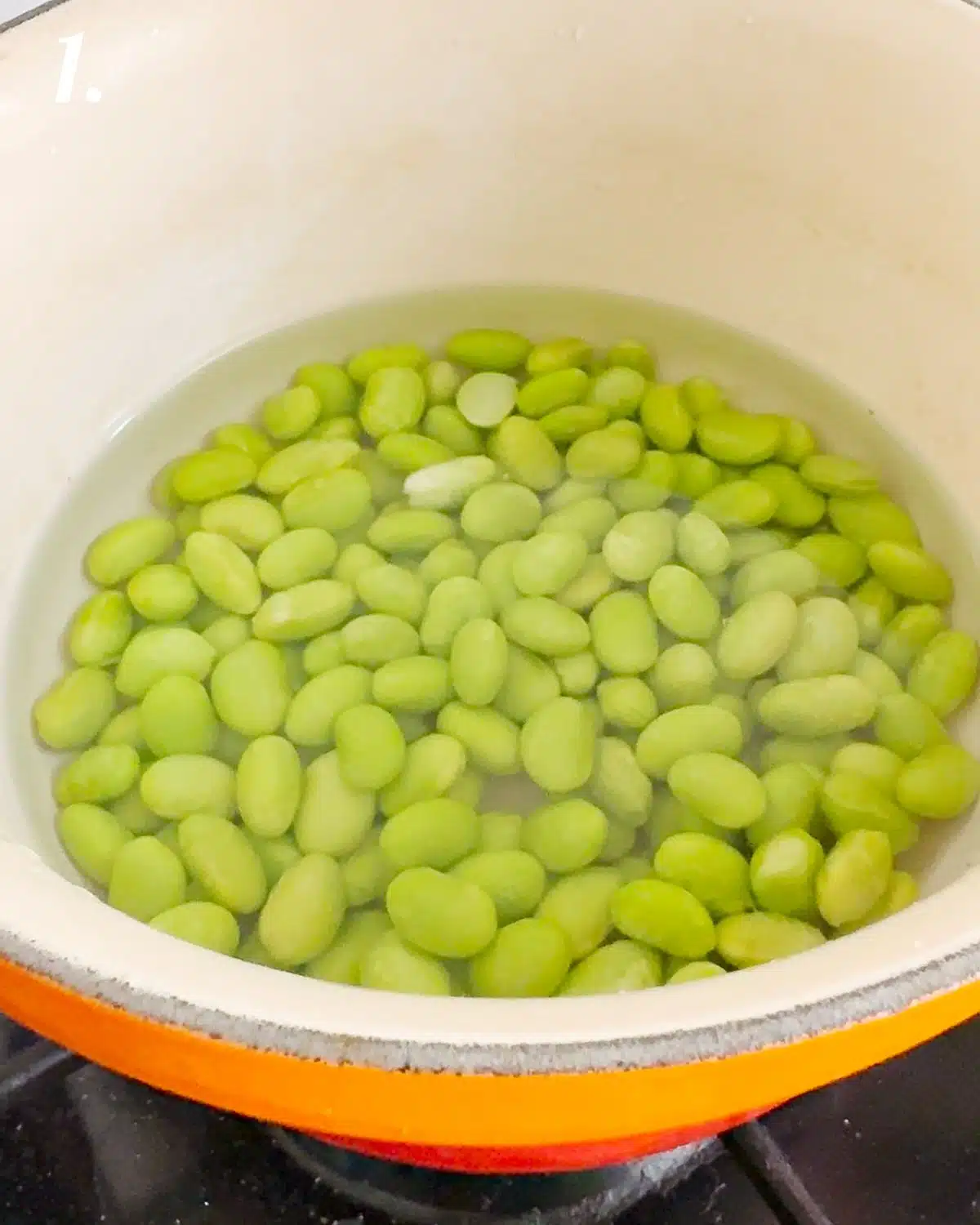 Boiling the edamame beans for a minute.