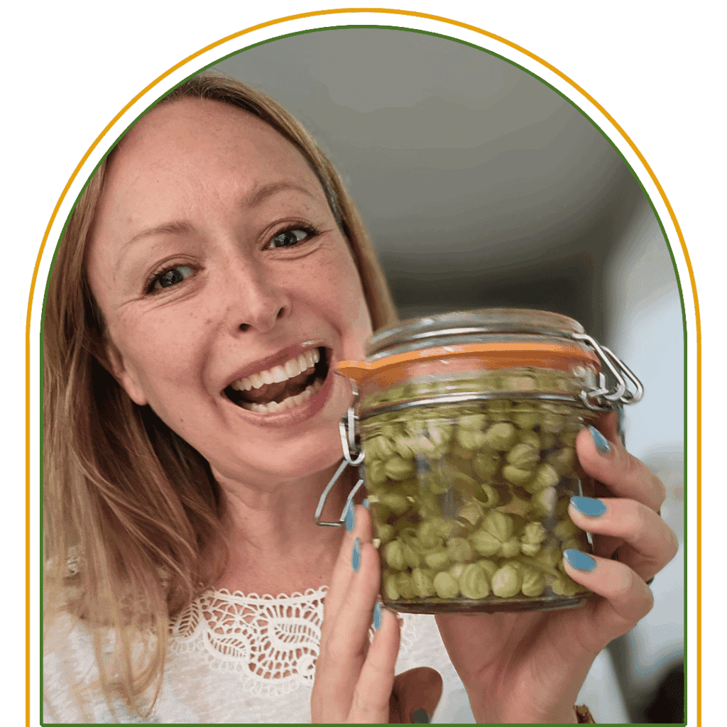 A photograph of Louise-Claire holding a jar of pickles.