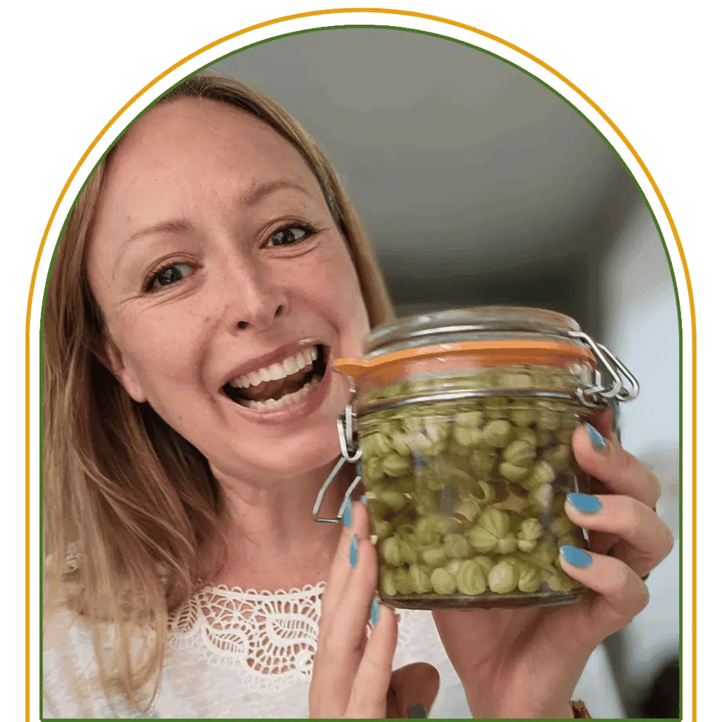 A photograph of Louise-Claire holding a jar of pickles.