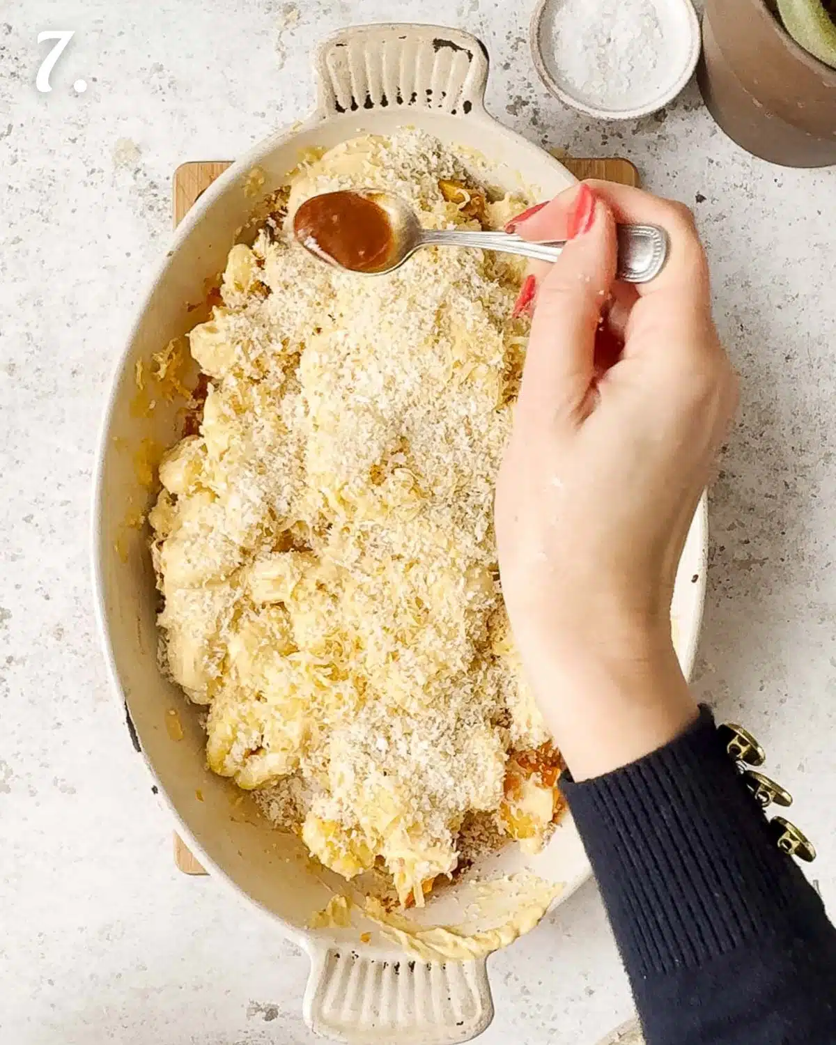 Topping the gnocchi bake with more harissa before it goes into the oven.