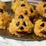Cute vegan arancini made to look like jack o'lanterns for halloween.