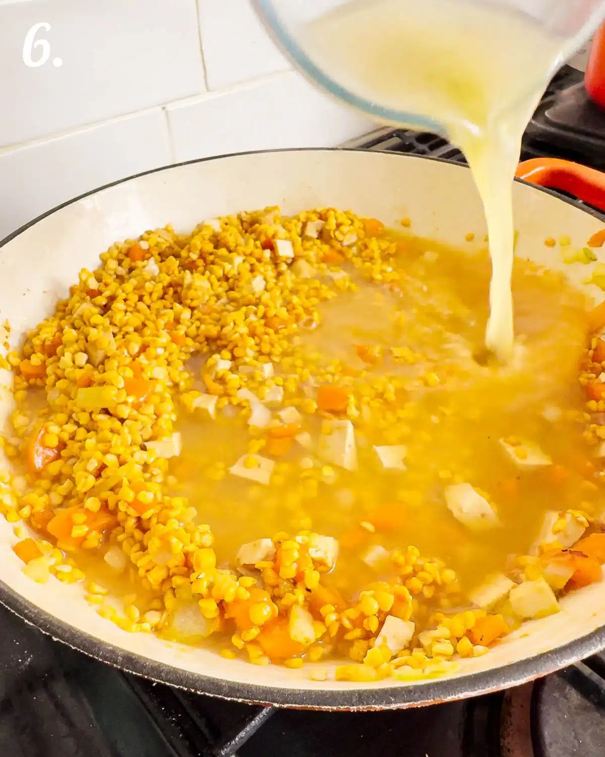 Showing the soup with broth being added to is.