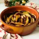 A dish of layered potatoes and beetroot boulangere style ready to serve.