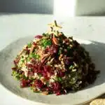 A large vegan Christmas cashew cheese ball ready to serve.