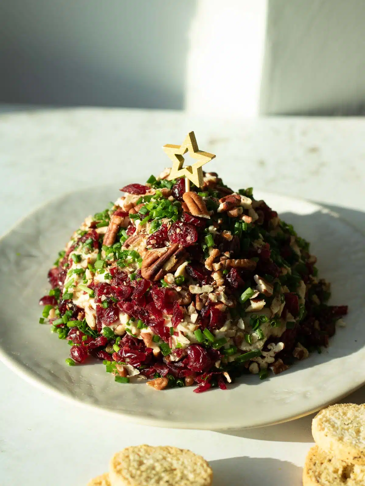 A large vegan Christmas cashew cheese ball ready to serve.