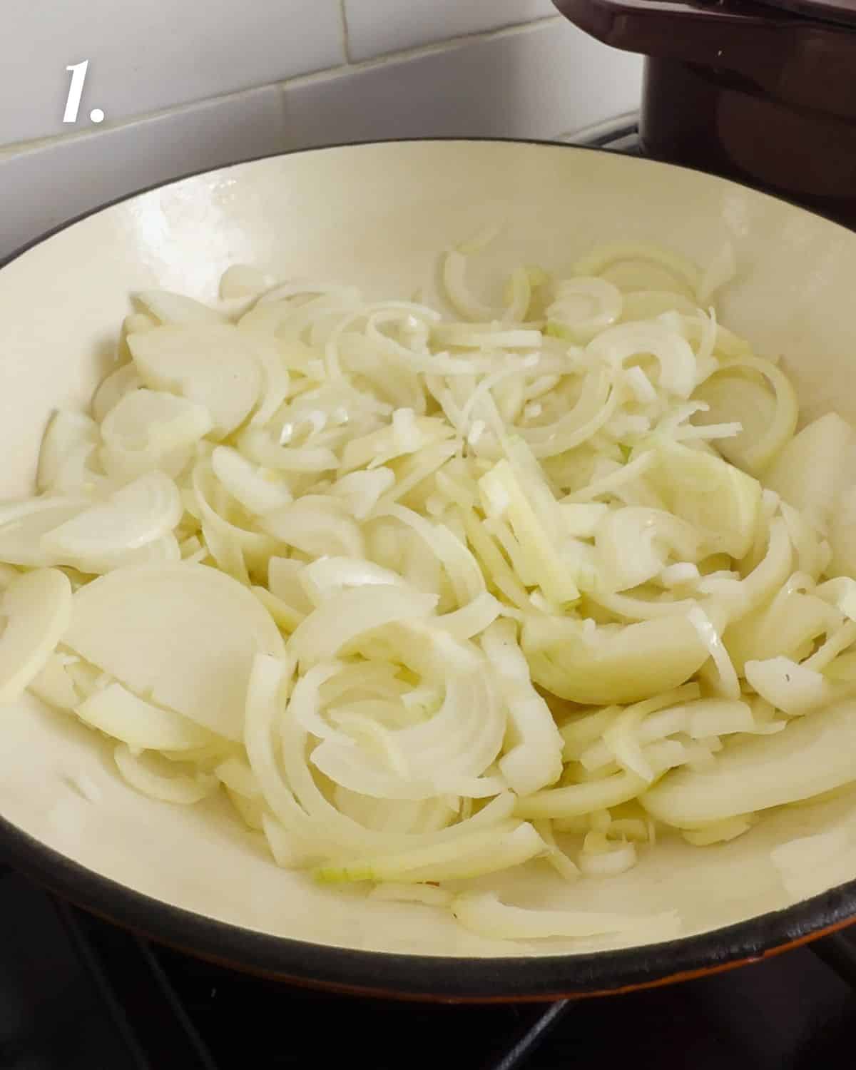 The sliced onions in a pan before they start cooking