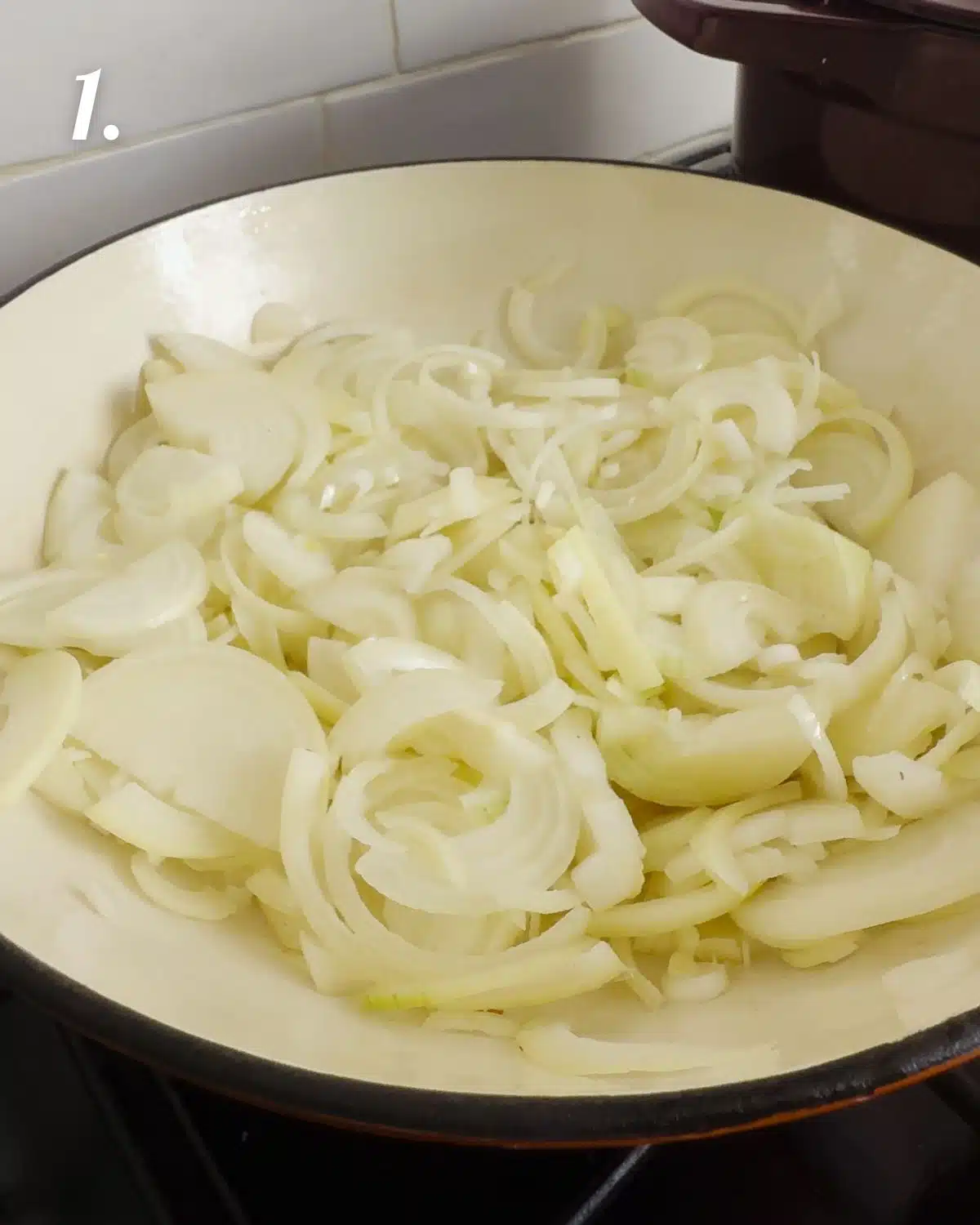 The sliced onions in a pan before they start cooking
