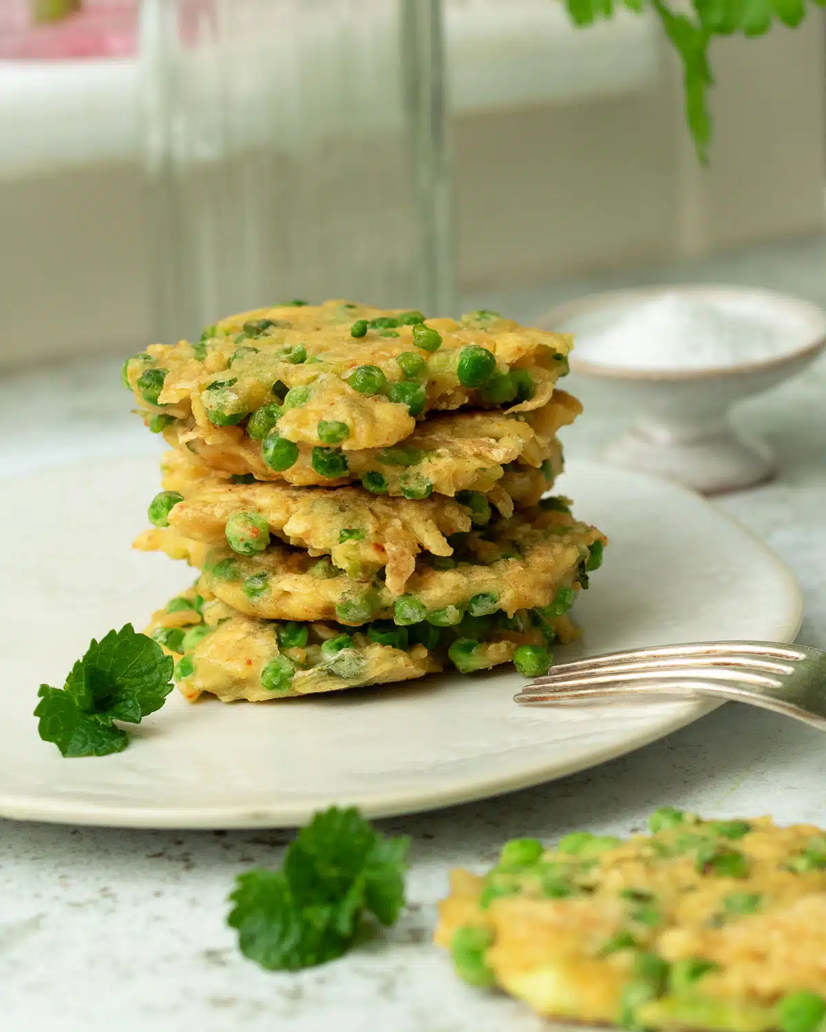 A stack of pea and tofu fritters on a plate.