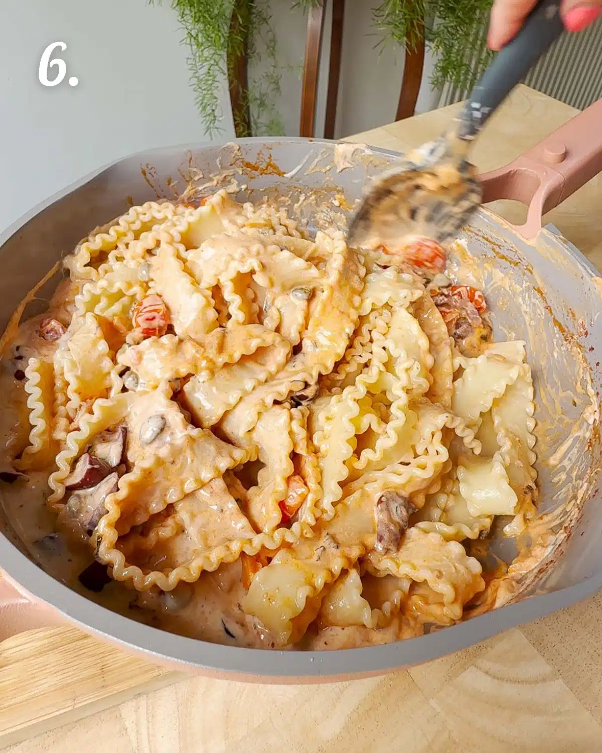 Stirring the pasta into the sauces with a little pasta water to help the sauce cling to the pasta.