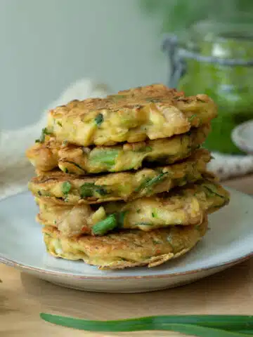 A stack of zucchini and white bean fritters ready to serve.