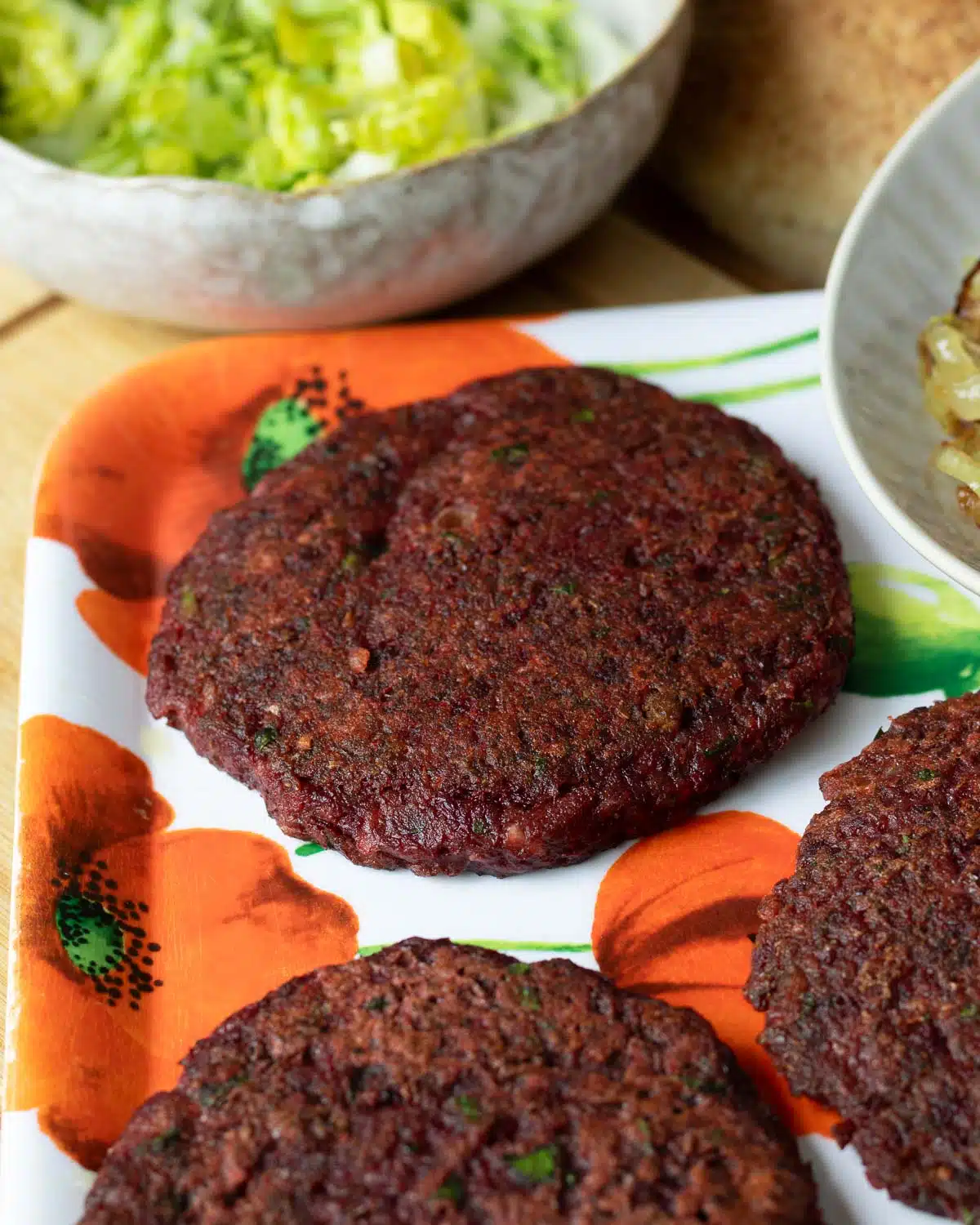 A tray with cooked lentil beet burgers on it ready to use.