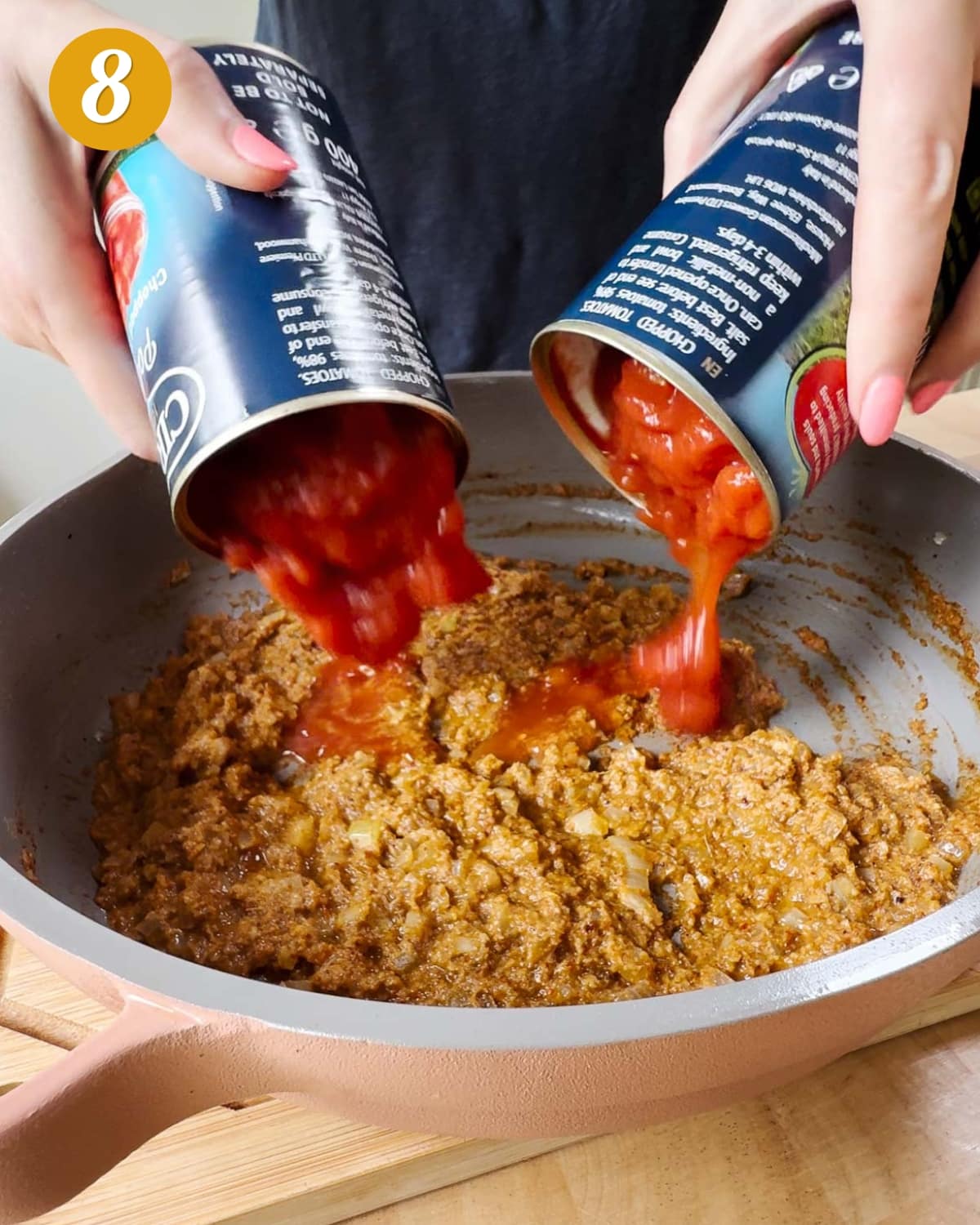 Add the tinned tomatoes to the spices and onions.