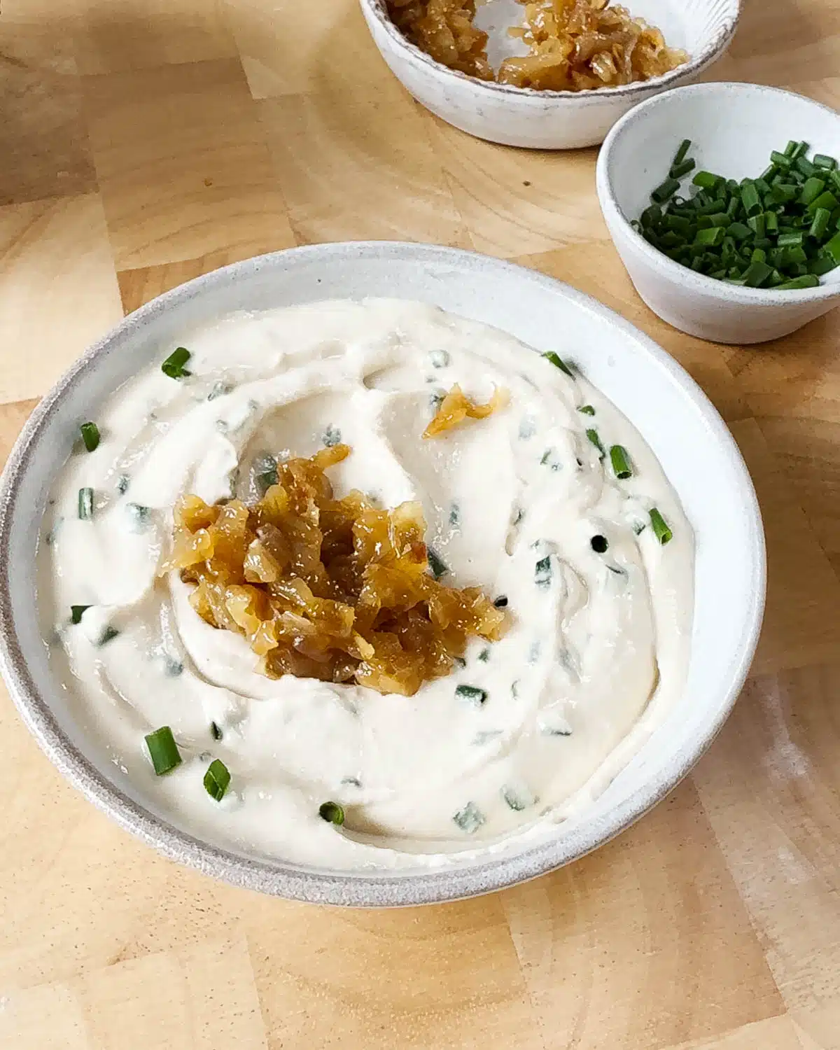 Showing the dip with the chives in it, topped with the caramelised onions.