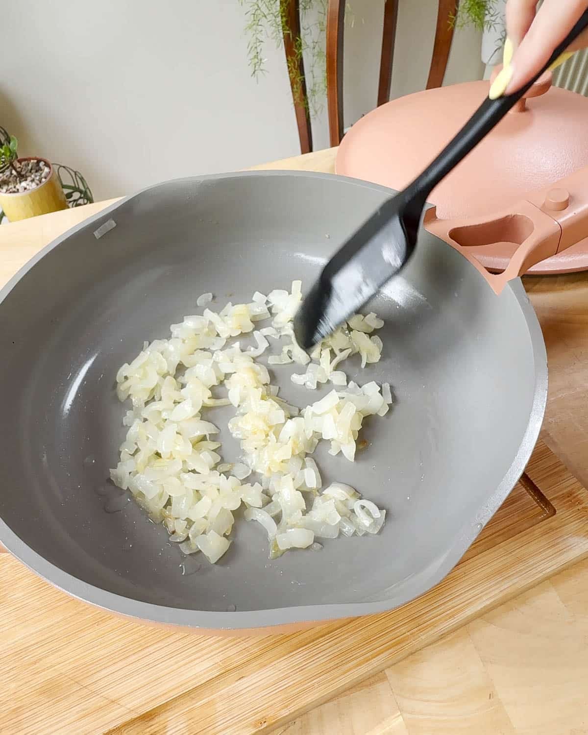 Showing a pan of finely chopped onions before cooking down to caramelise.
