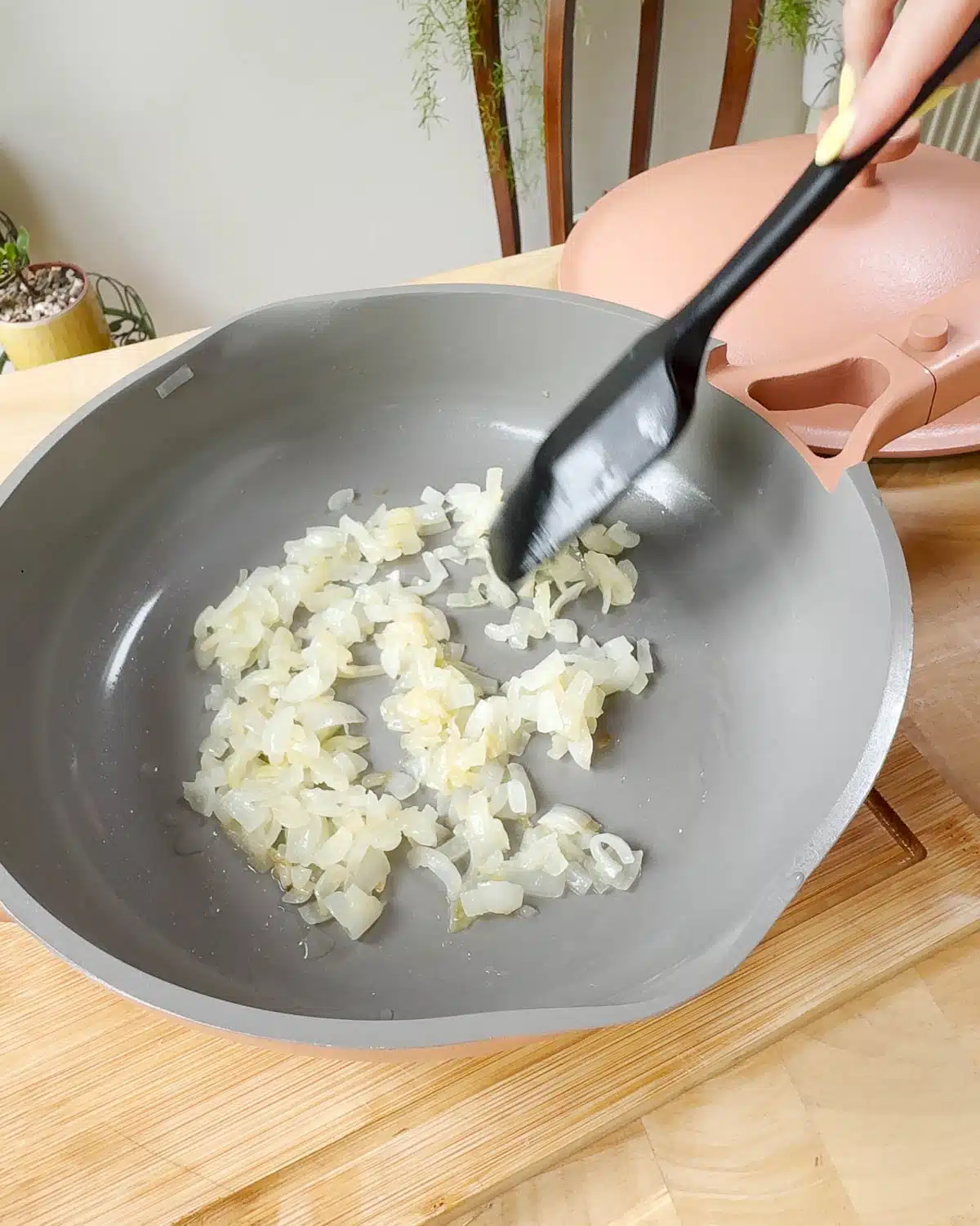 Showing a pan of finely chopped onions before cooking down to caramelise.