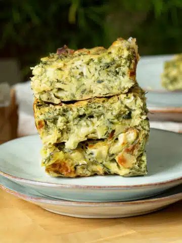 A stack of zucchini slice on a plate ready to eat.