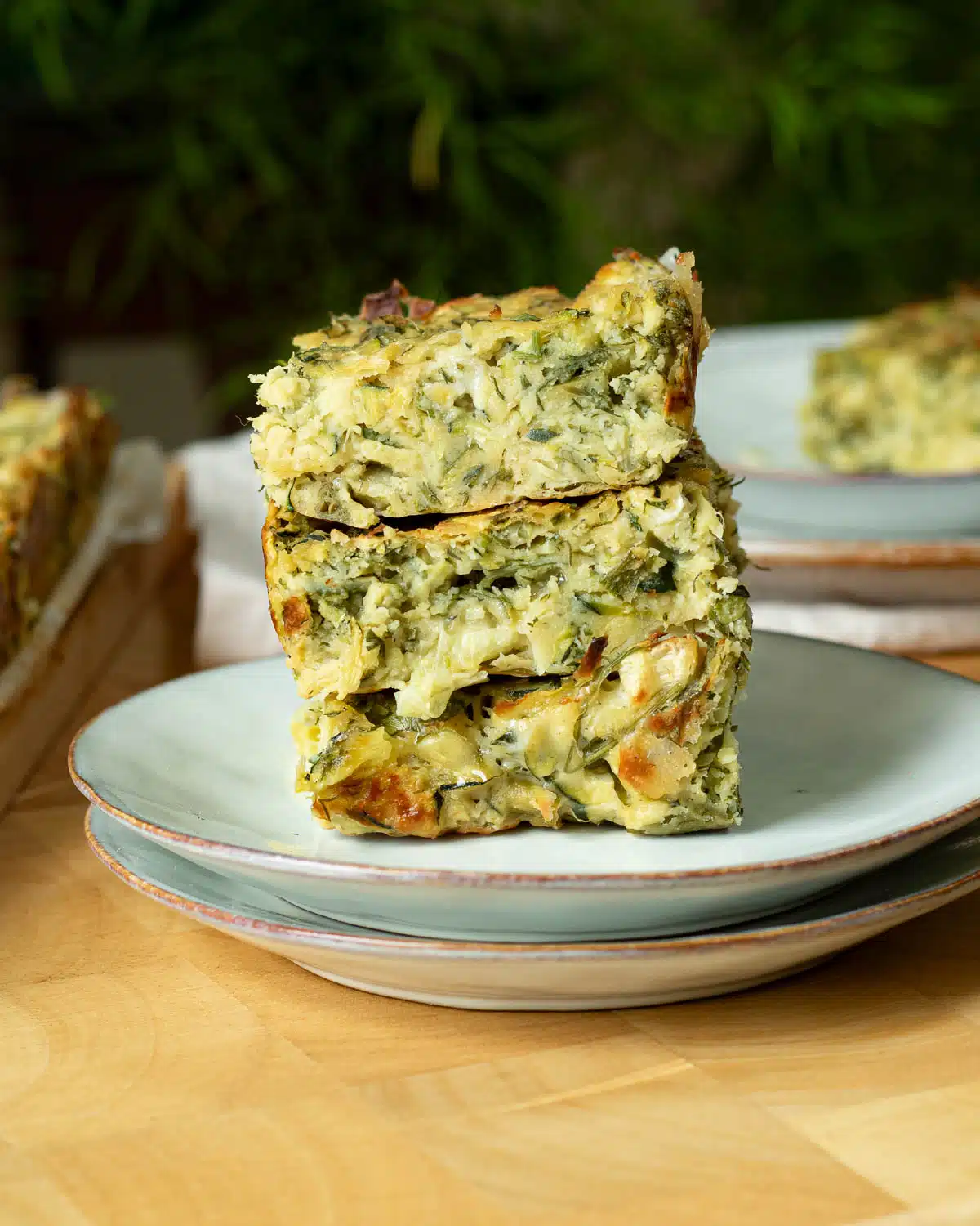 A stack of vegan aussie style zucchini slice on a plate. 