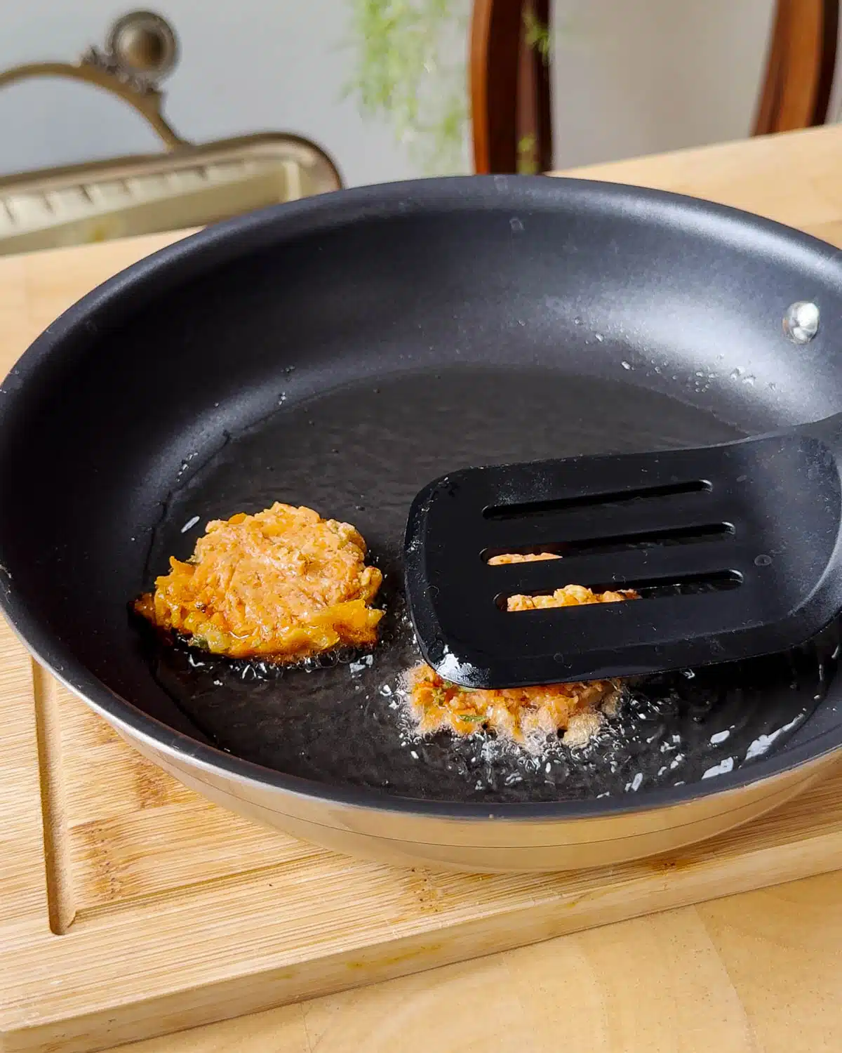 Heat oil, put scoops of fritter batter into the oil and press down so you have a nice round patty. Flip when golden brown.