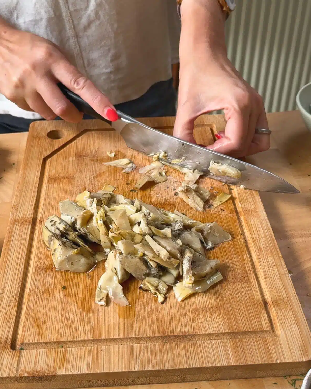 Finely chopping the artichokes for the crab cakes.