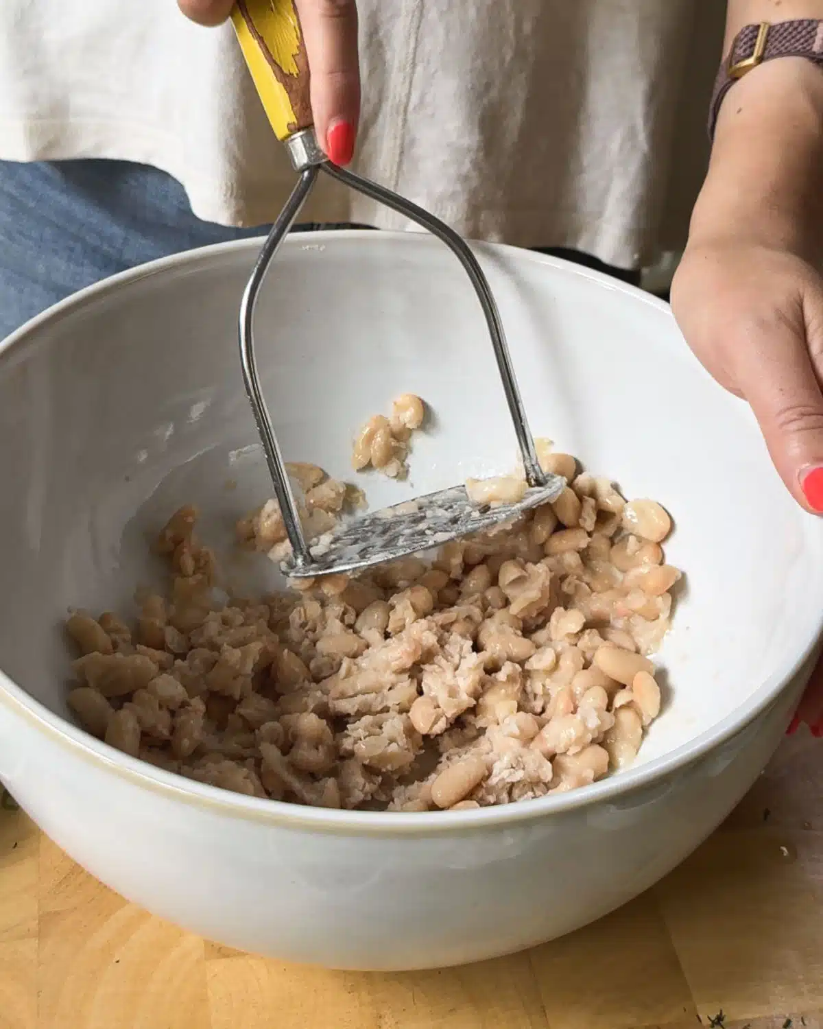 Mashing the white beans for the crab cakes.