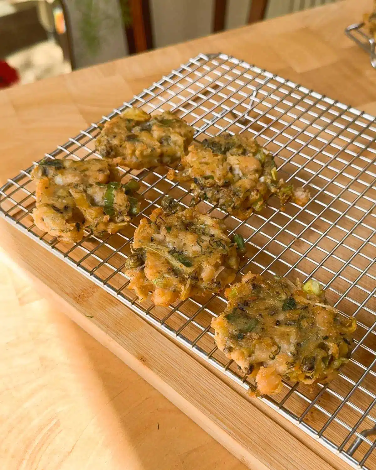 Draining the crab cakes to keep them crispy before serving.