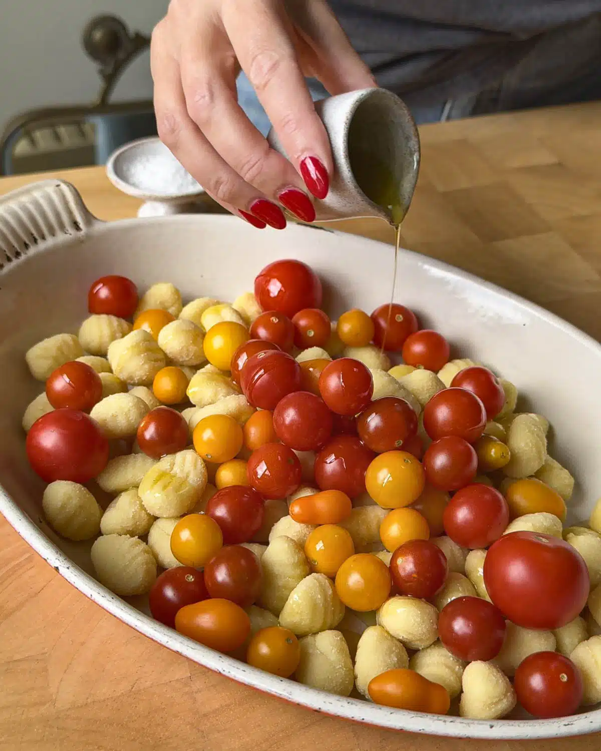 Add the gnocchi and tomatoes to a casserole or baking dish. Drizzle with olive oil and salt. Put in the oven.