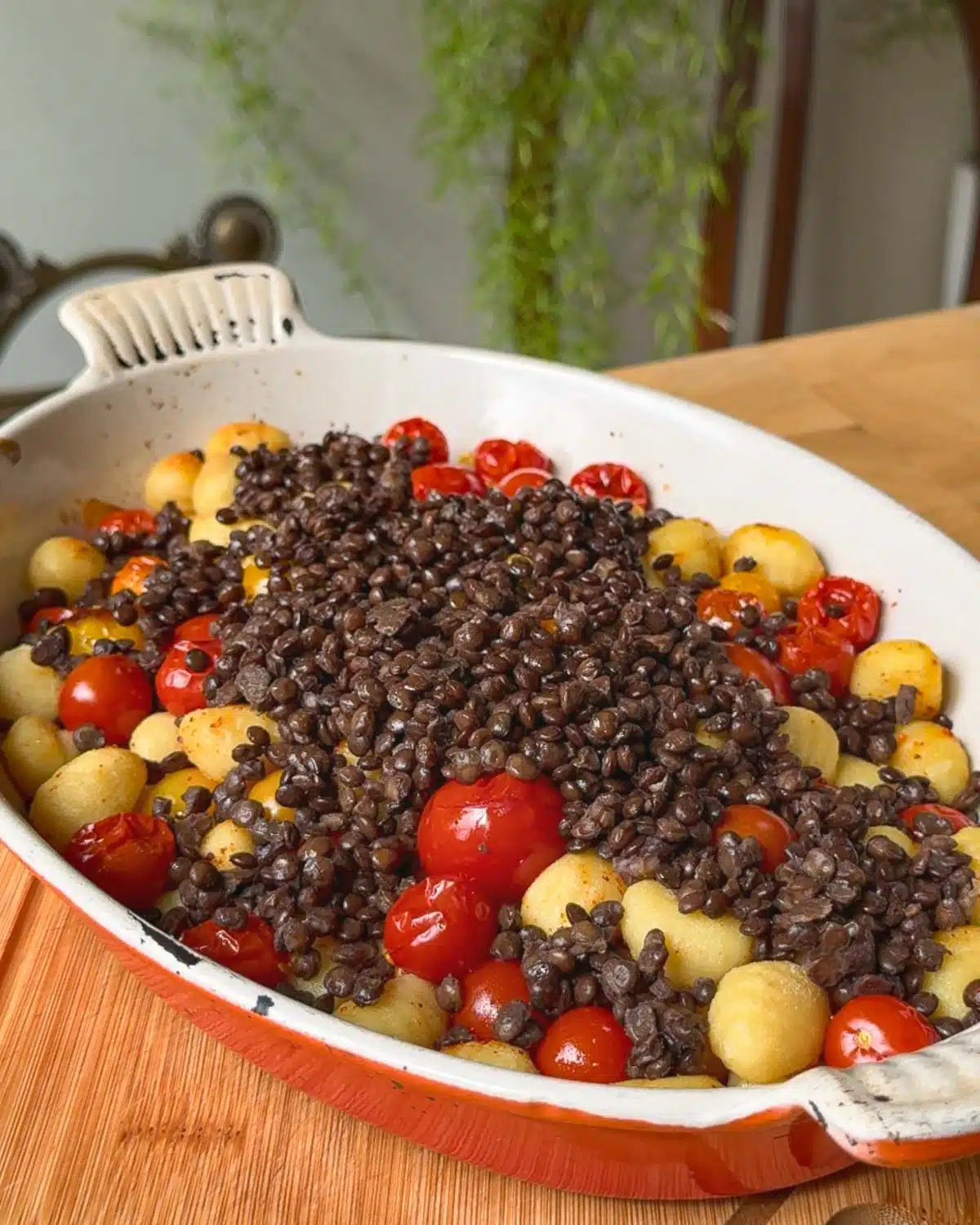 Remove the gnocchi and tomatoes from the oven. Mix in cooked lentils.