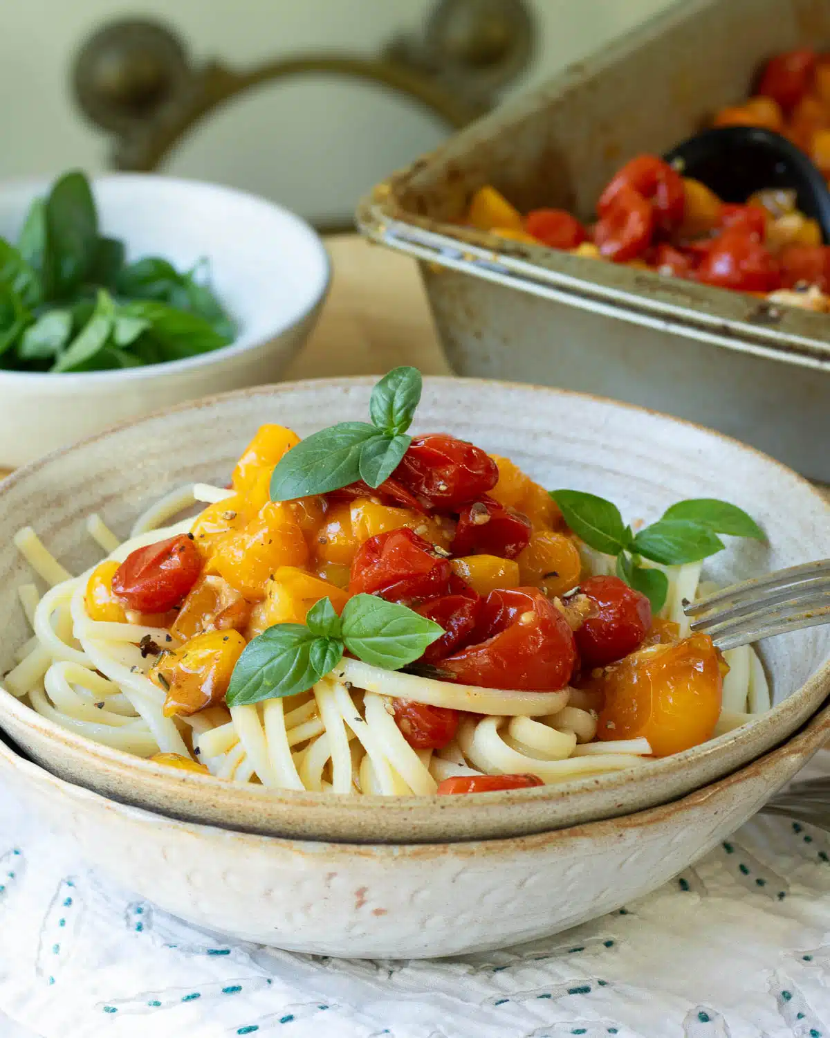 A bowl of pasta with roasted tomato pasta sauce on top.