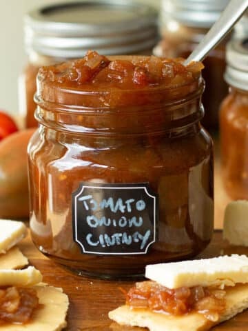 A jar of tomato and onion chutney ready to add to crackers and have with cheese.