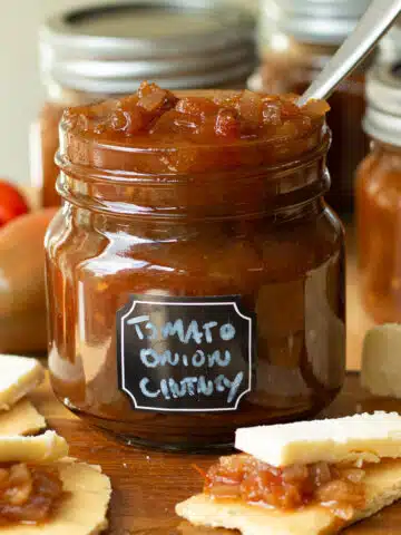 A jar of tomato and onion chutney ready to add to crackers and have with cheese.