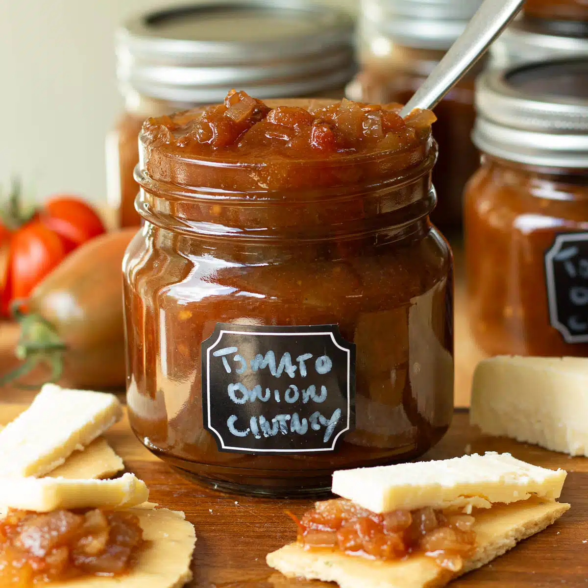 A jar of tomato and onion chutney ready to add to crackers and have with cheese.