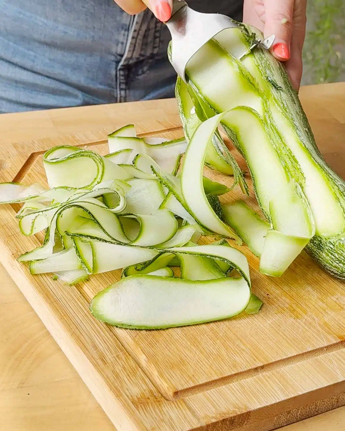 Shave the zucchini into ribbons using a vegetable peeler.