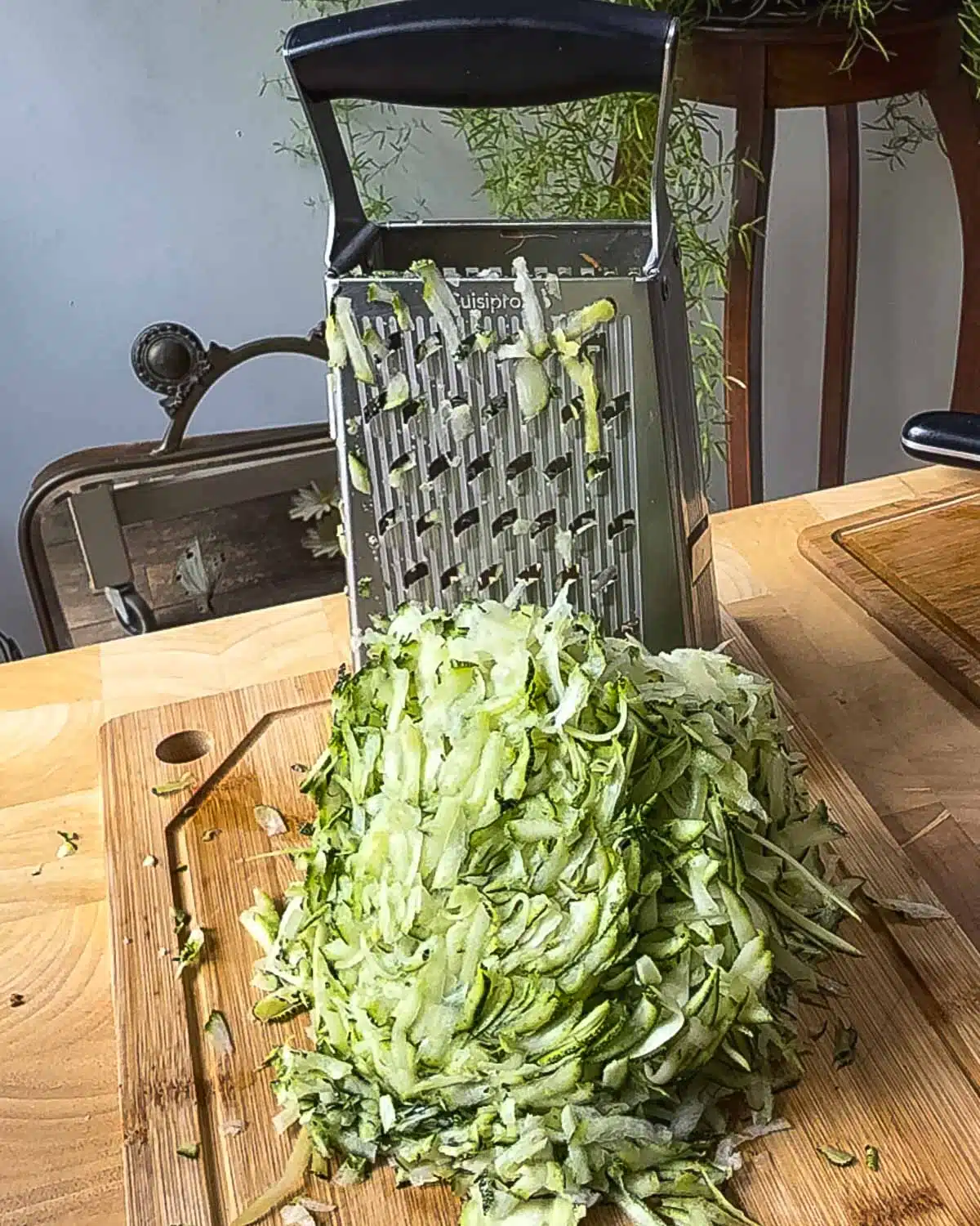 Grate the zucchini and other vegetables.