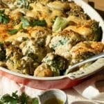 A casserole dish with broccoli and gnocchi in a cheesy sauce ready to eat.