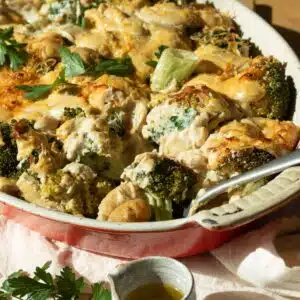A casserole dish with broccoli and gnocchi in a cheesy sauce ready to eat.
