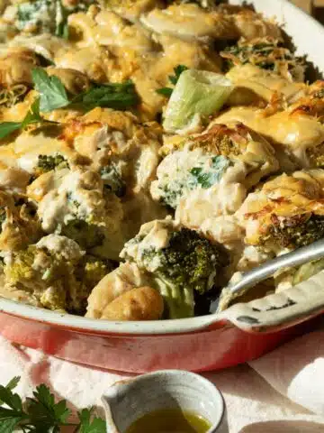 A casserole dish with broccoli and gnocchi in a cheesy sauce ready to eat.