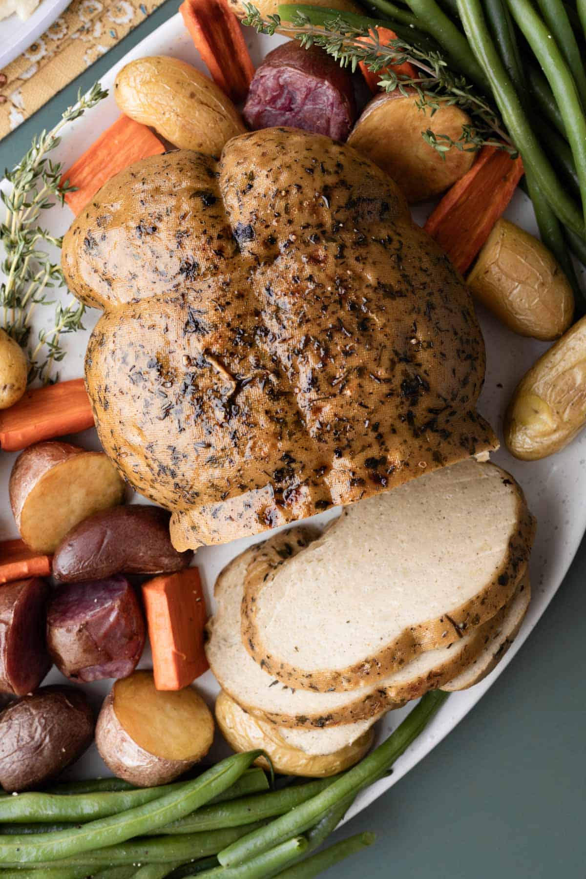 A roasted seitan turkey with herb crusted skin.