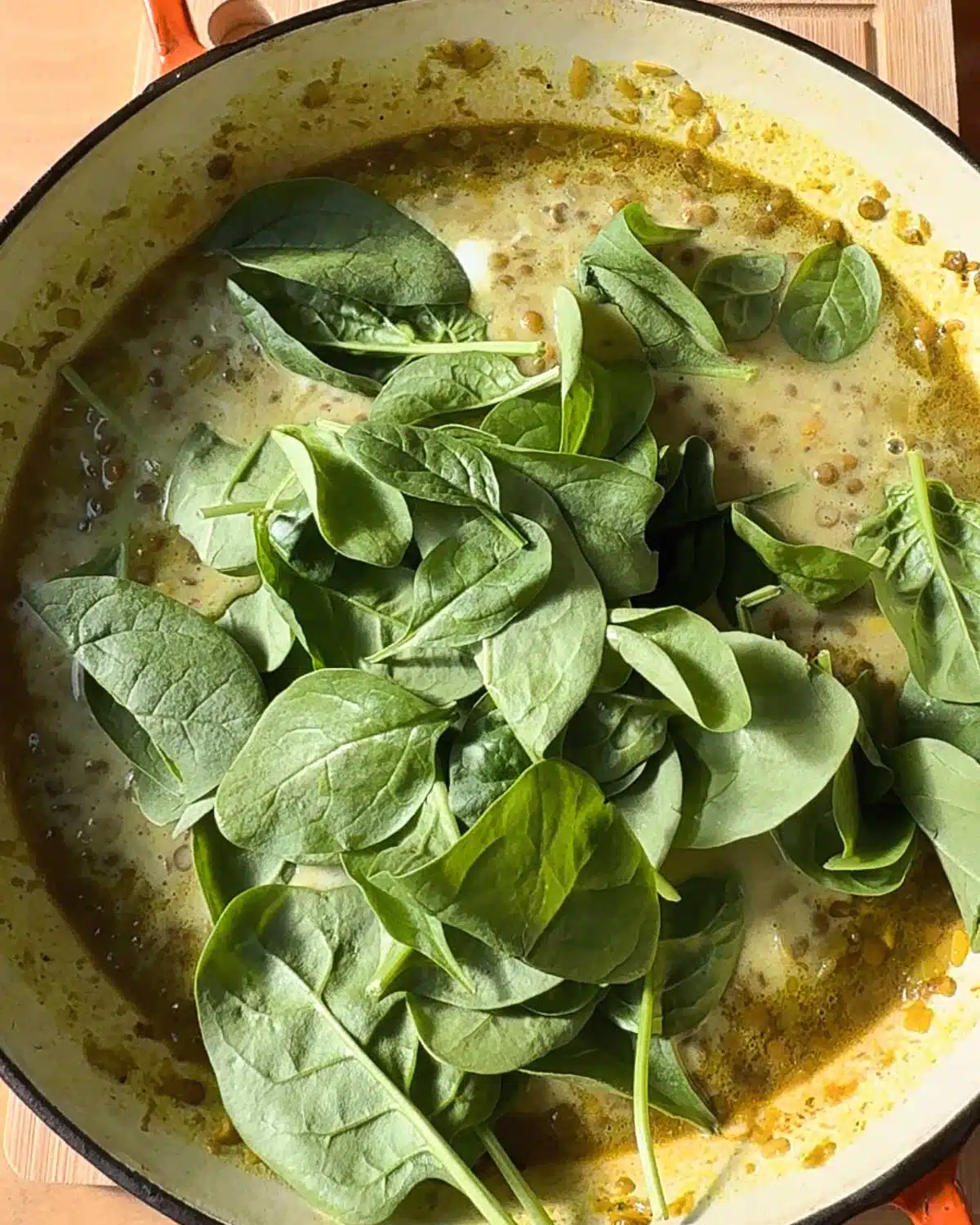 Wilt the spinach or other greens into the soup.